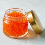Salmon roe on a jar with golden lid