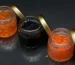 Black and red caviar jars with golden lid